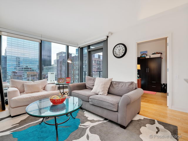 60 East Monroe Street, Unit 1906 Chicago, IL 60603 - Photo 7 of 20 a living room with furniture and a large window