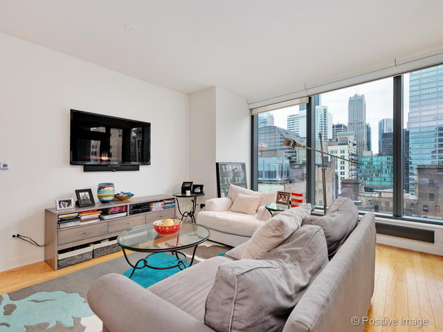 60 East Monroe Street, Unit 1906 Chicago, IL 60603 - Photo 8 of 20 a living room with furniture and a flat screen tv