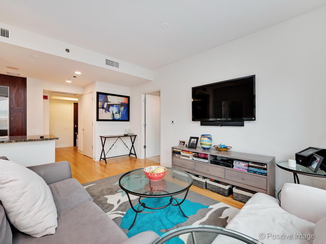 60 East Monroe Street, Unit 1906 Chicago, IL 60603 - Photo 9 of 20 a living room with furniture and a flat screen tv