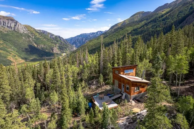 an aerial view of a house with a yard