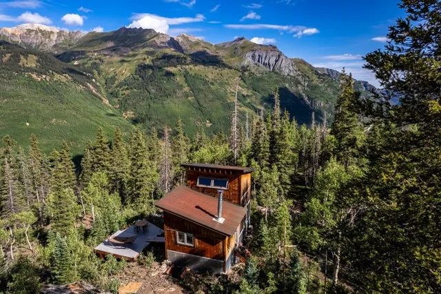 an aerial view of a house with yard and outdoor seating