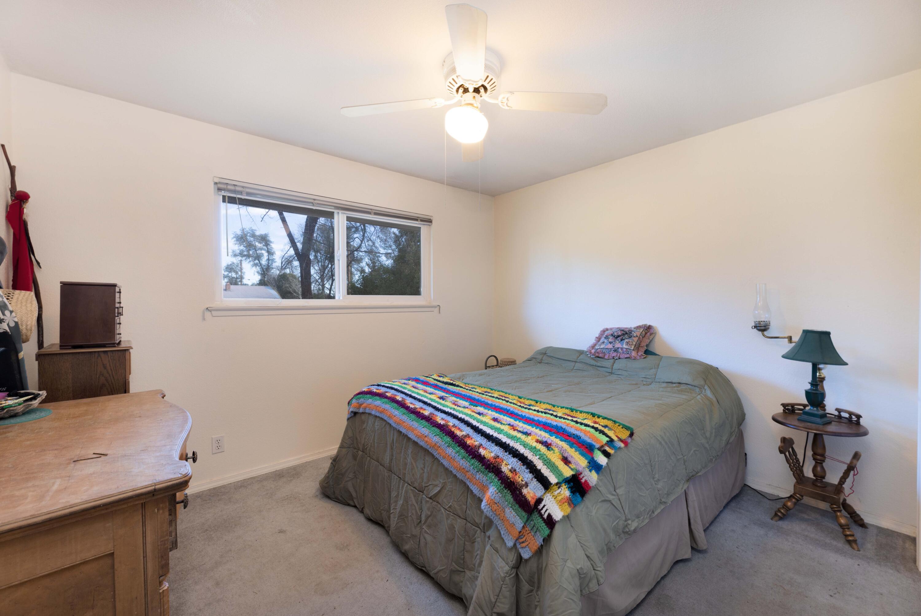 8790 Redbank Road Redding, CA 96001 - Photo 15 of 21 a bedroom with a bed and a flat screen tv