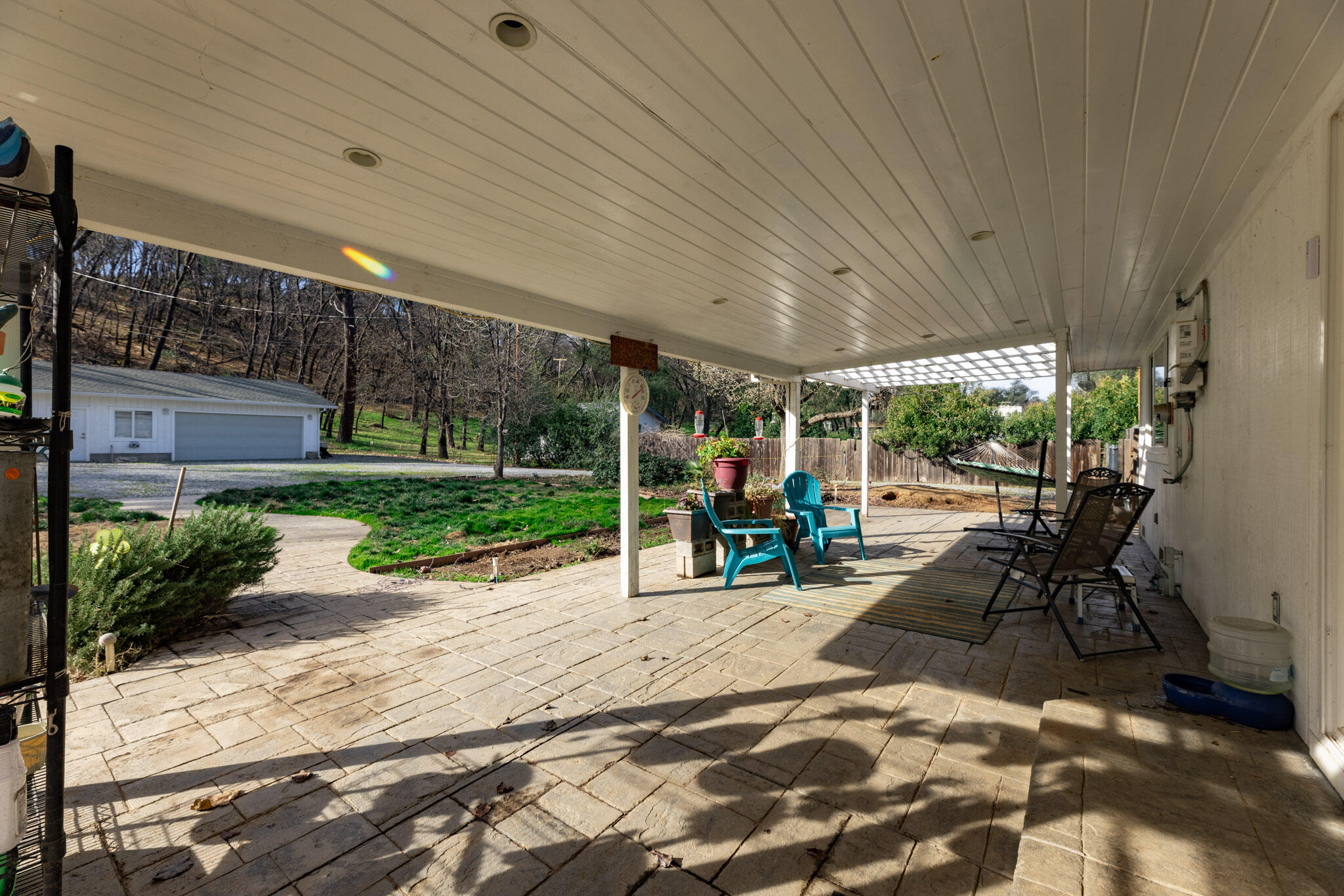8790 Redbank Road Redding, CA 96001 - Photo 16 of 21 a view of a patio with table and chairs potted plants with wooden floor and fence