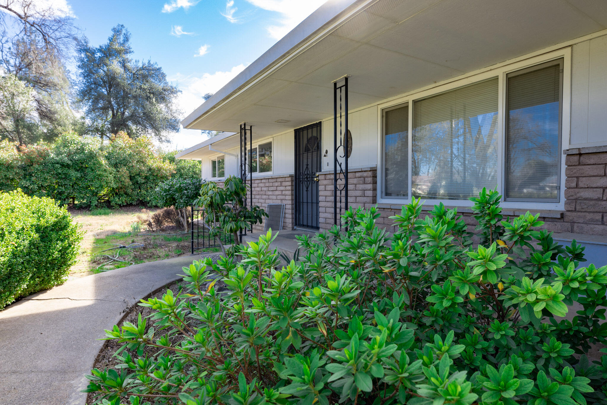 8790 Redbank Road Redding, CA 96001 - Photo 2 of 21 a view of a house with a small yard and plants