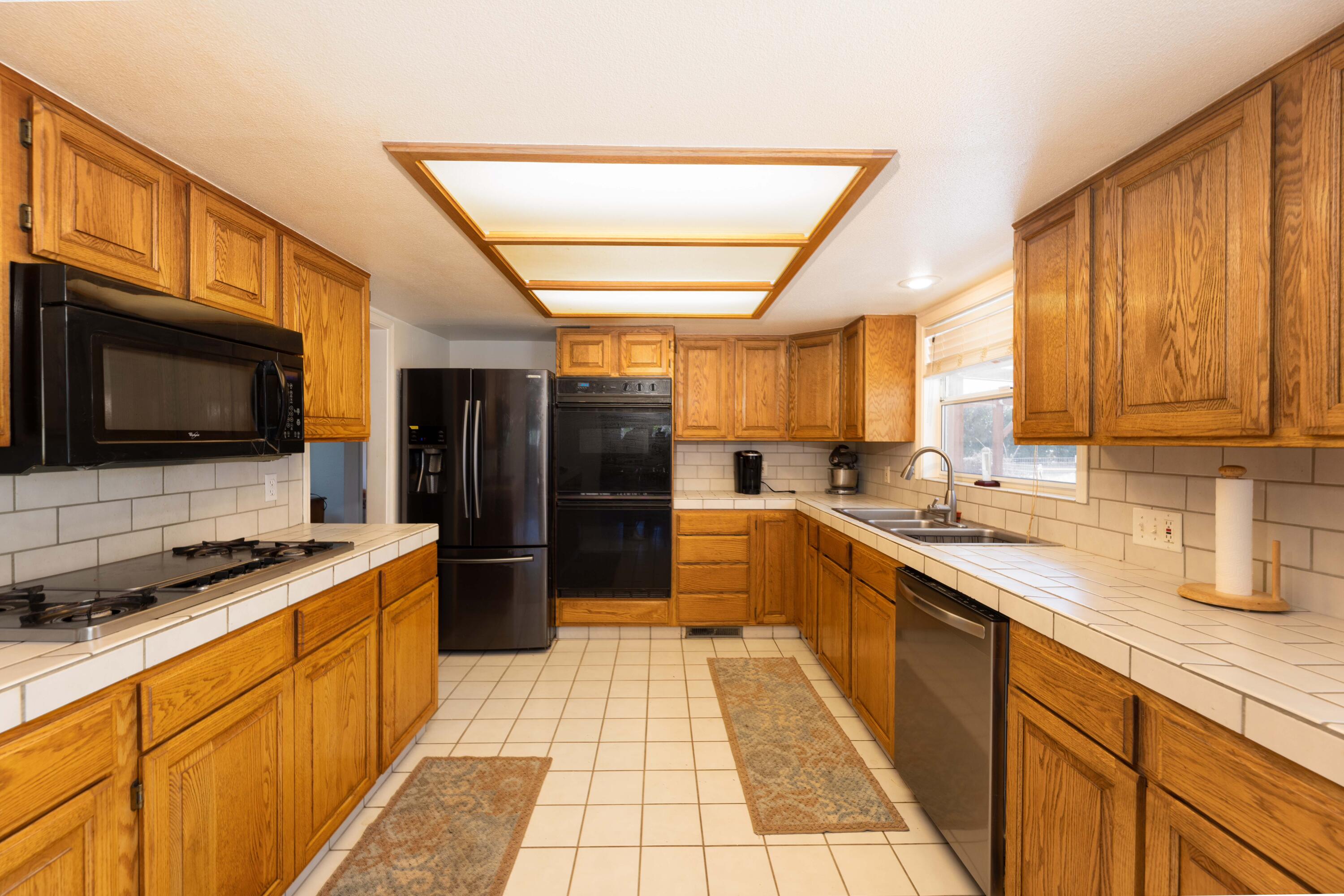 8790 Redbank Road Redding, CA 96001 - Photo 3 of 21 a kitchen with stainless steel appliances a stove sink microwave and cabinets