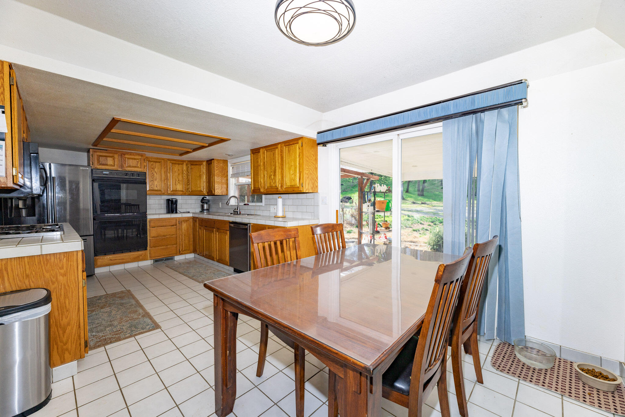 8790 Redbank Road Redding, CA 96001 - Photo 5 of 21 a view of a dining room with furniture window and wooden floor