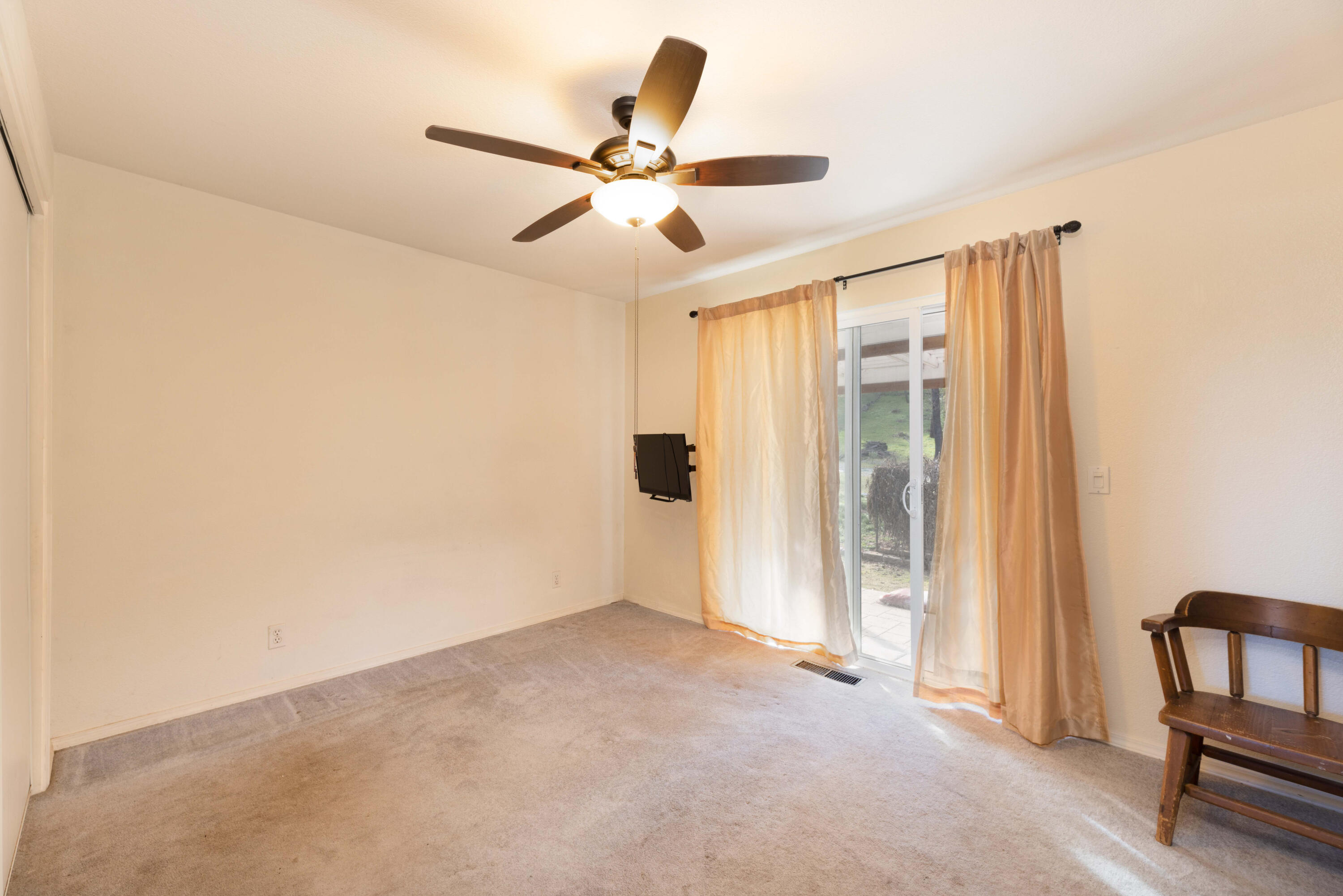 8790 Redbank Road Redding, CA 96001 - Photo 9 of 21 a view of a livingroom with a ceiling fan and wooden floor