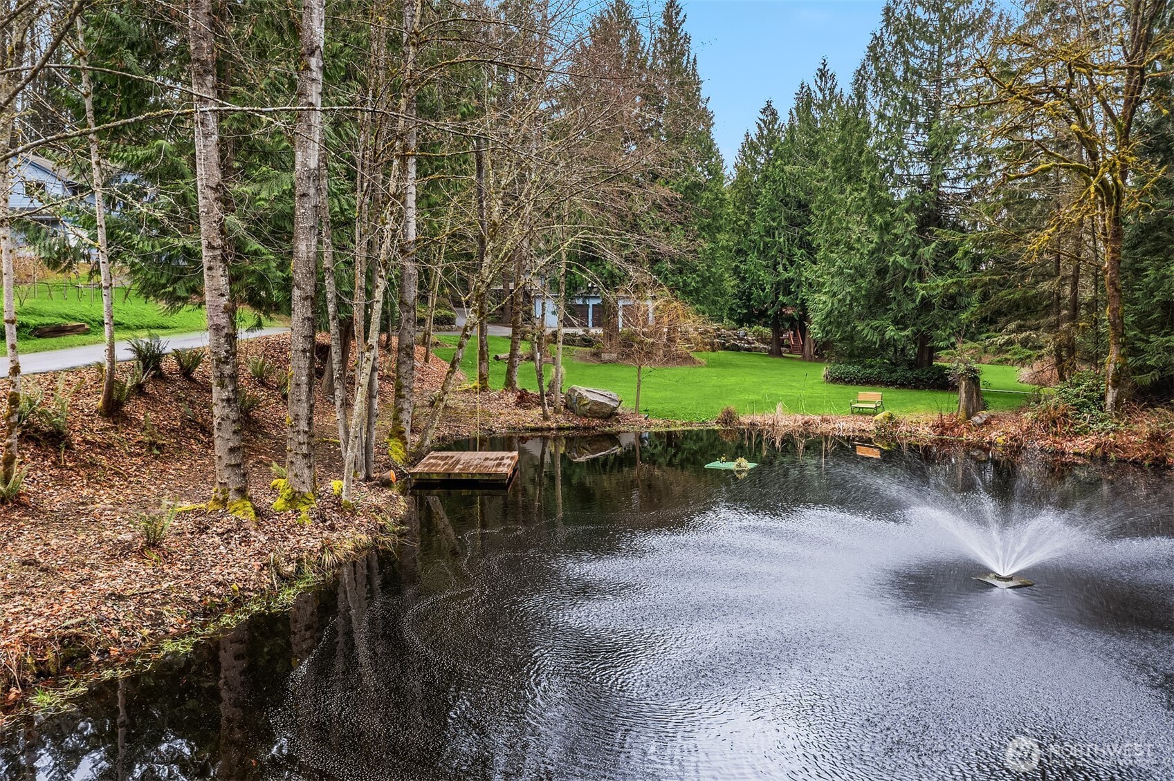 21407 Northeast Union Hill Road Redmond, WA 98053 - Photo 2 of 40 a view of a lake with a yard and outdoor seating