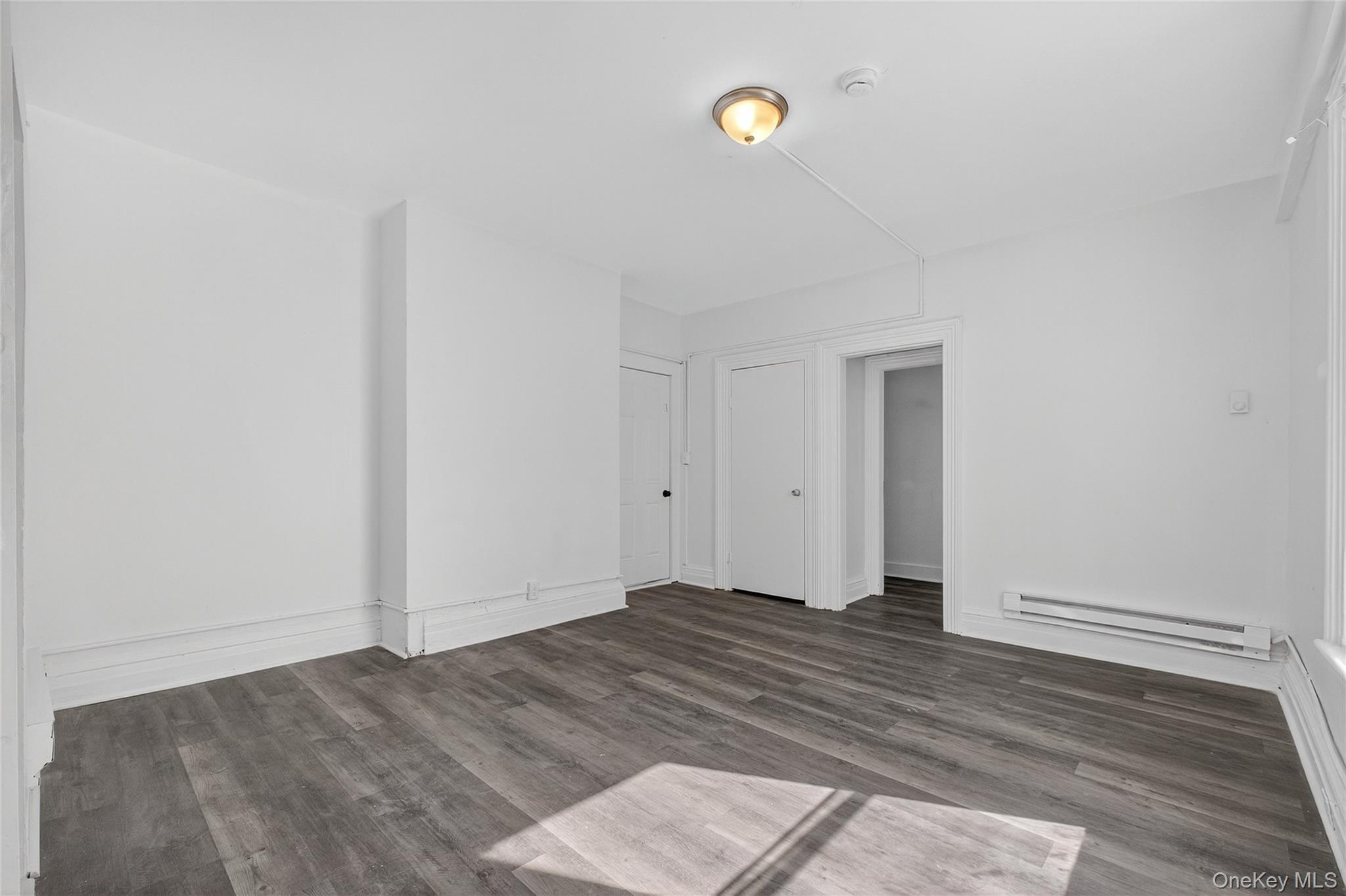 49 South Hamilton Street, Unit 2 Poughkeepsie, NY 12601 - Photo 7 of 20 a view of an empty room with wooden floor and a window