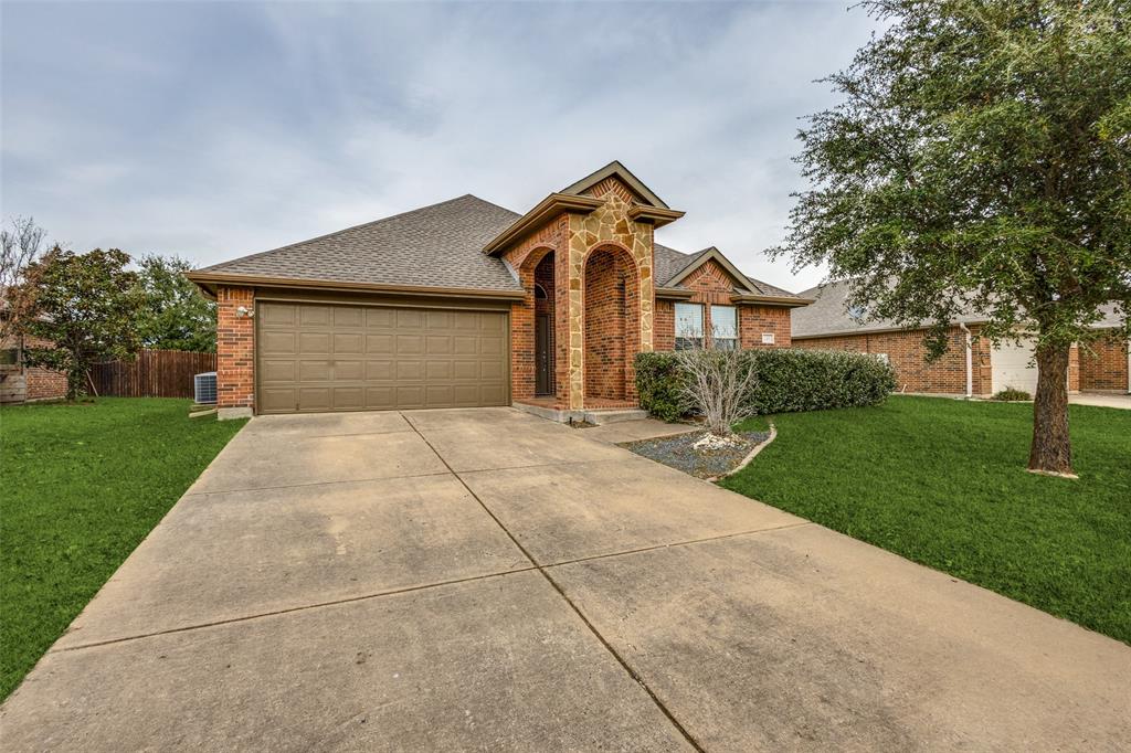 145 Mill Street Anna, TX 75409 - Photo 2 of 25 a front view of a house with a yard and garage