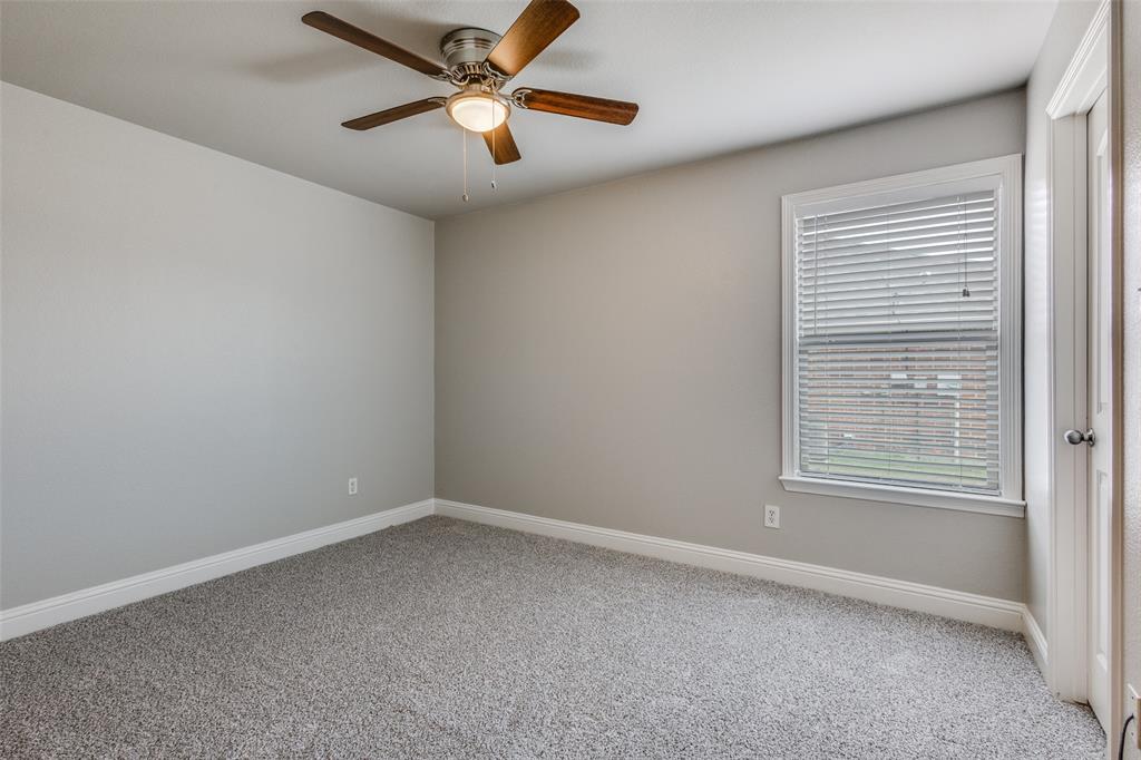 145 Mill Street Anna, TX 75409 - Photo 20 of 25 an empty room with a window and a fan