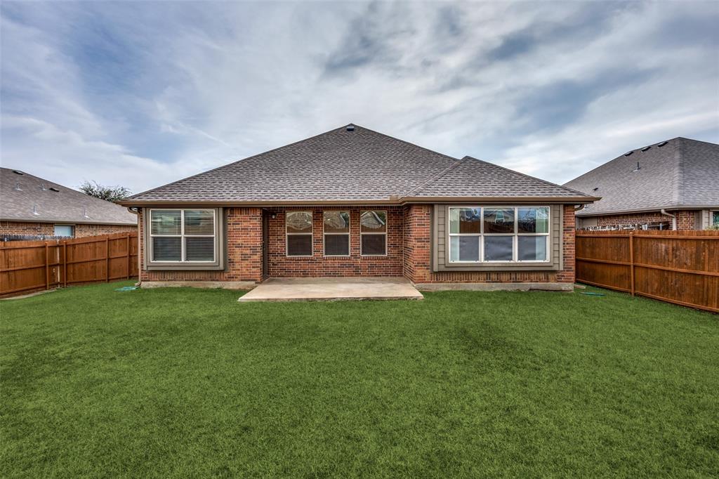 145 Mill Street Anna, TX 75409 - Photo 23 of 25 a front view of a house with a garden