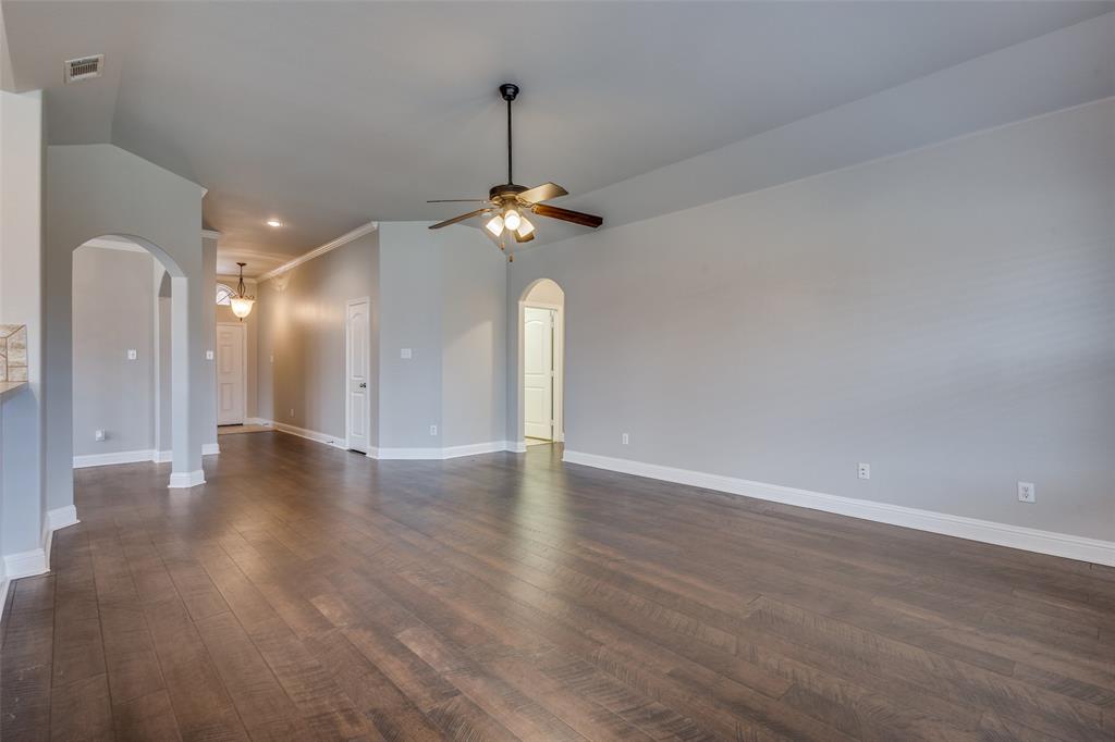145 Mill Street Anna, TX 75409 - Photo 4 of 25 a view of a room with a chandelier fan and wooden floor