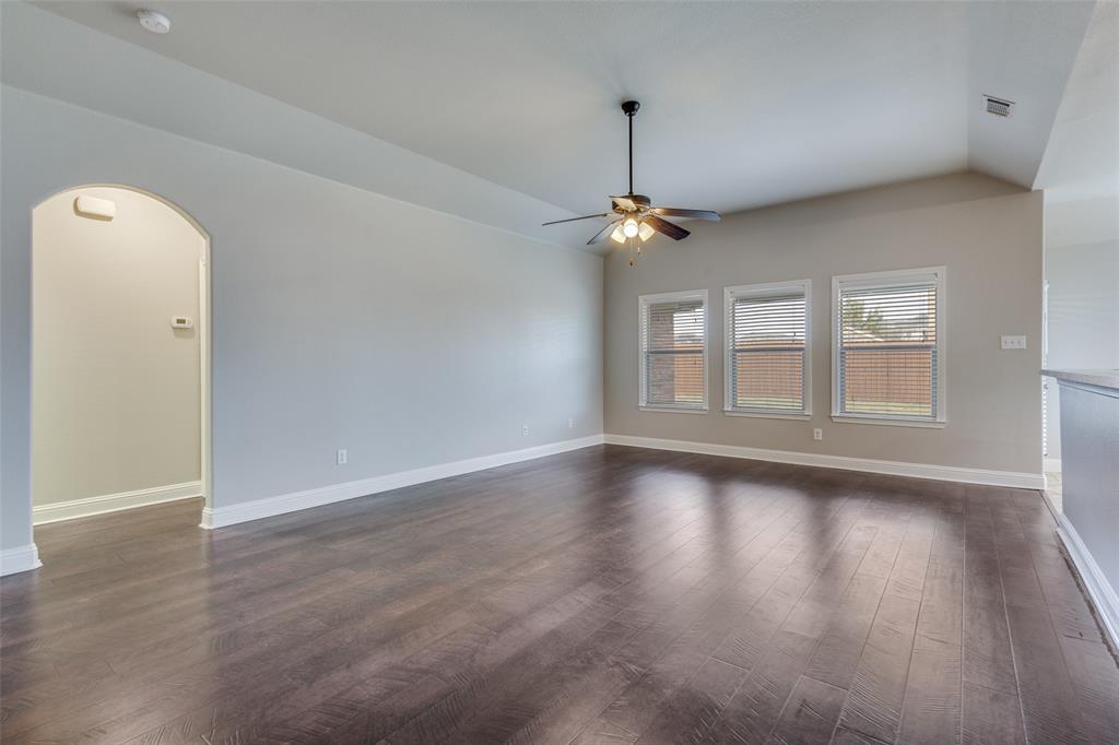 145 Mill Street Anna, TX 75409 - Photo 5 of 25 a view of an empty room with window and wooden floor