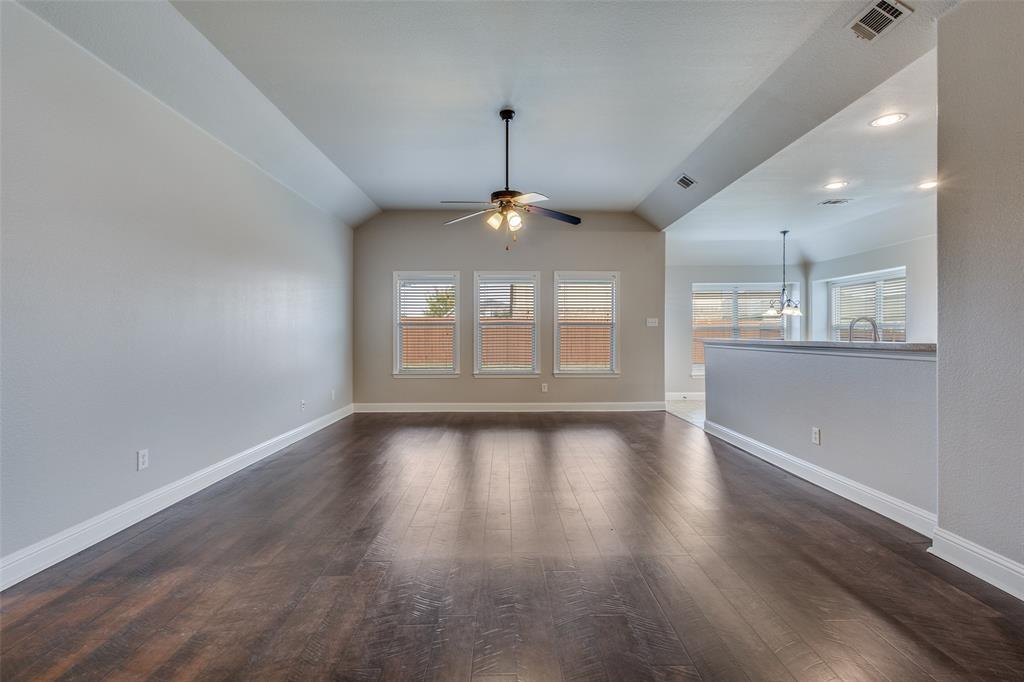 145 Mill Street Anna, TX 75409 - Photo 8 of 25 a view of an empty room with wooden floor and a window