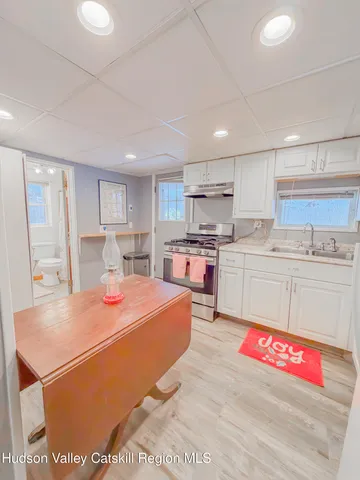 a kitchen with white cabinets and white appliances