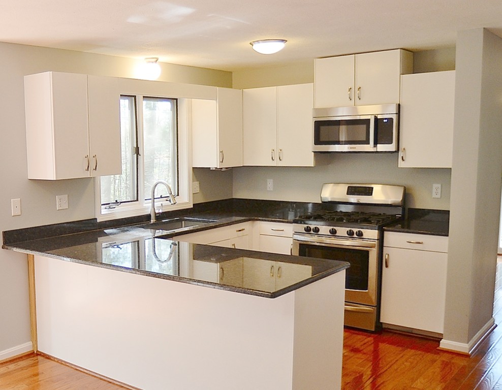 306 Fox Run Road, Unit 306 Hudson, NH 03051 - Photo 10 of 29 a kitchen with stainless steel appliances granite countertop a sink stove and microwave