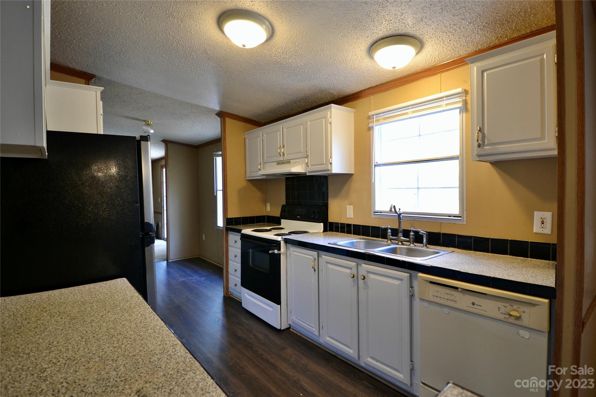 555 Kepley Road Salisbury, NC 28147 - Photo 9 of 39 a kitchen with granite countertop a sink stove and cabinets