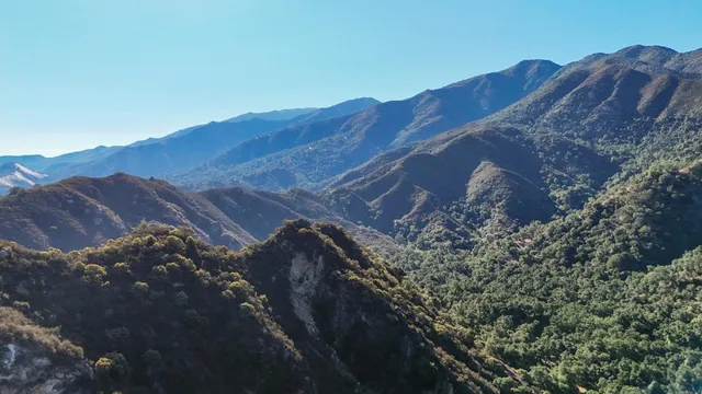 a view of a house with a mountain in the background