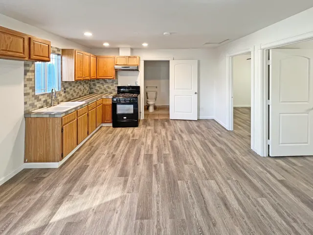 a large kitchen with a lot of counter space and stainless steel appliances