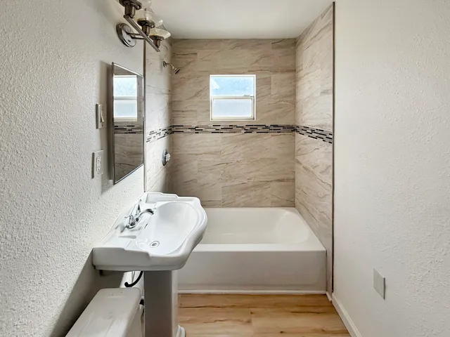 a bathroom with a sink and shower