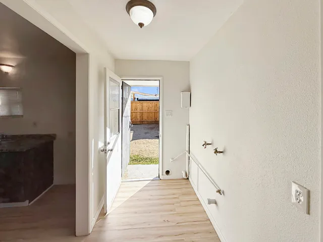 a view of a room with wooden floor