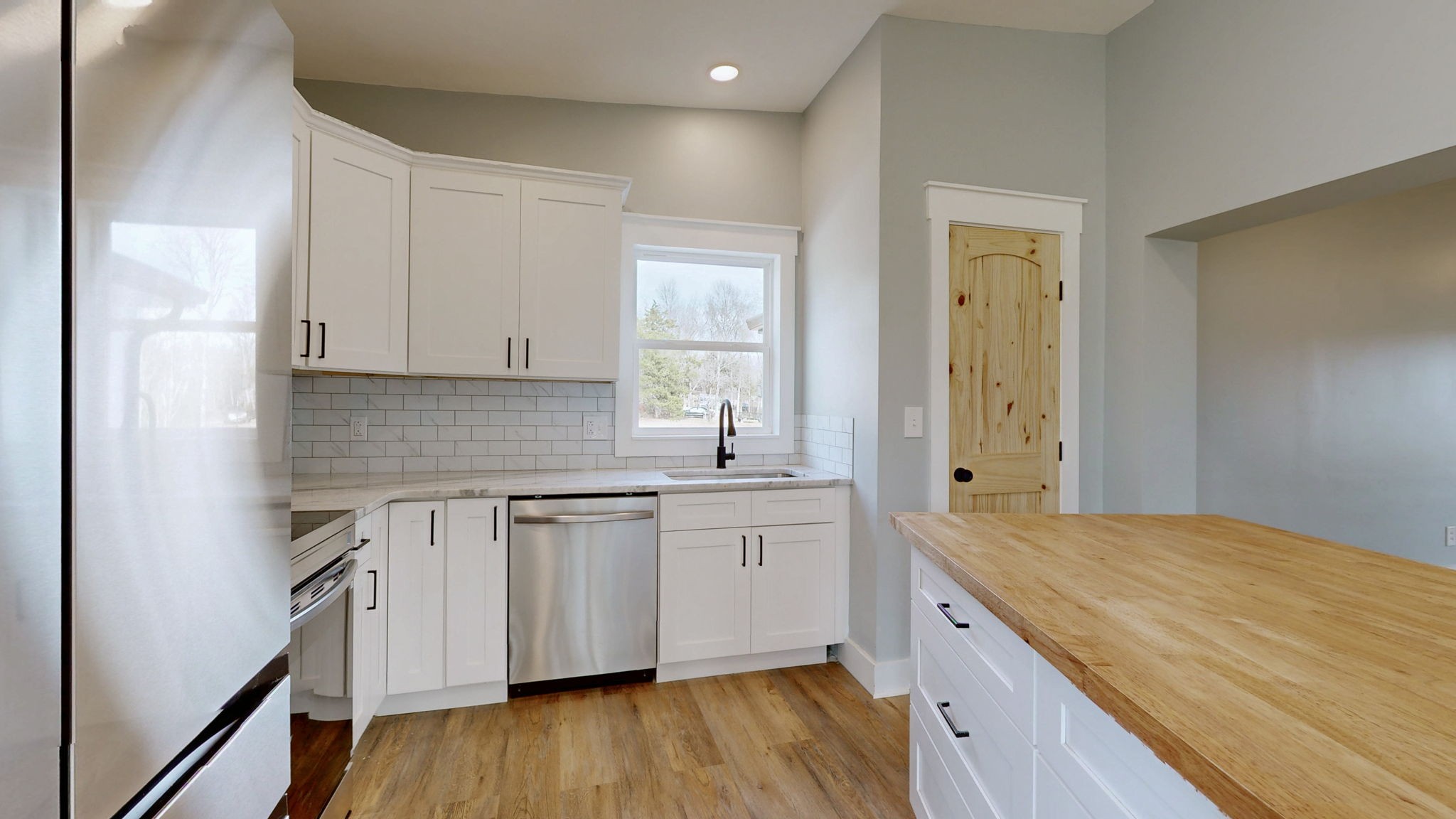 94 Bond Road Lebanon, TN 37090 - Photo 13 of 32 a kitchen with granite countertop a sink cabinets and wooden floor