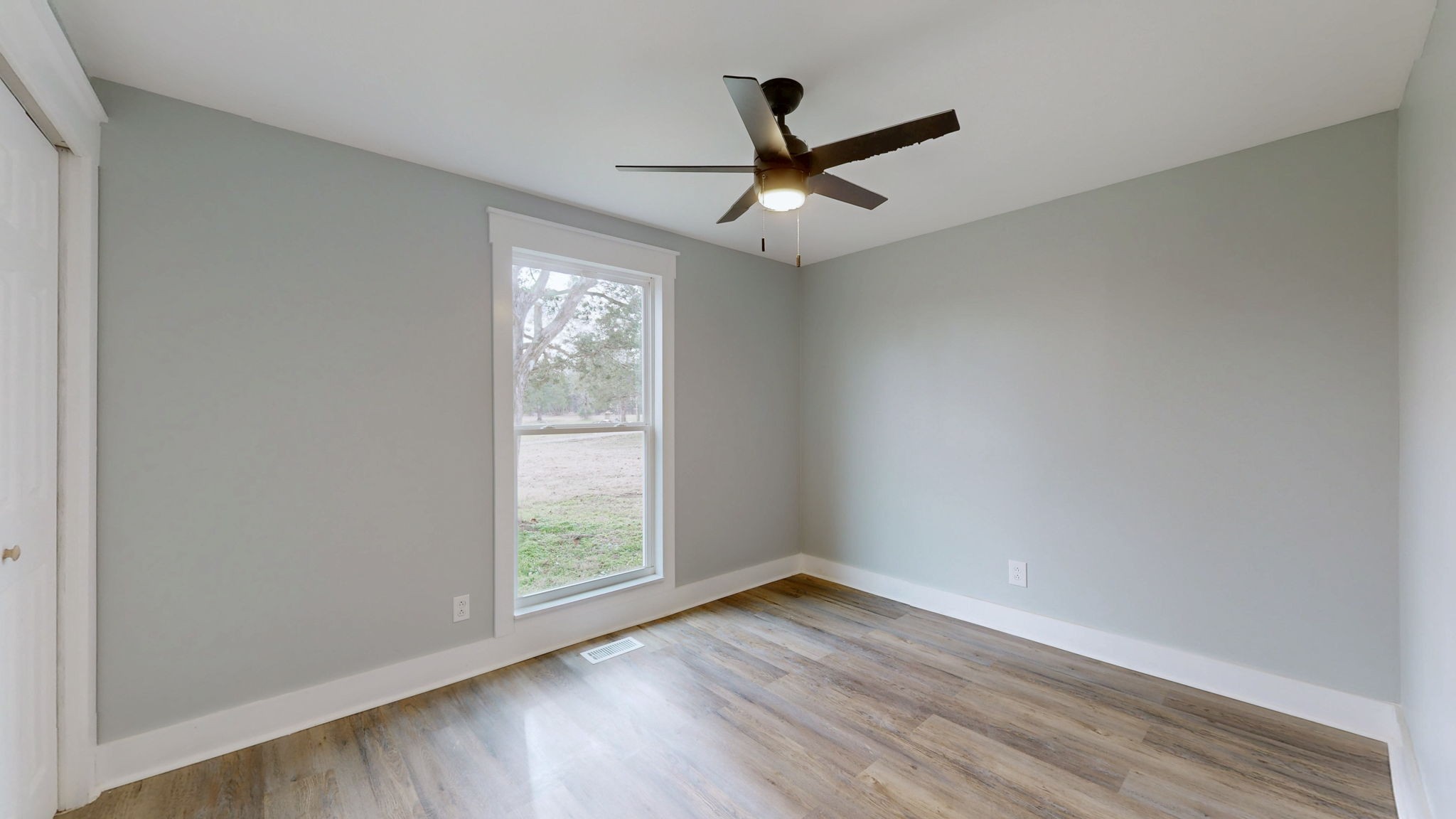 94 Bond Road Lebanon, TN 37090 - Photo 23 of 32 an empty room with wooden floor fan and windows