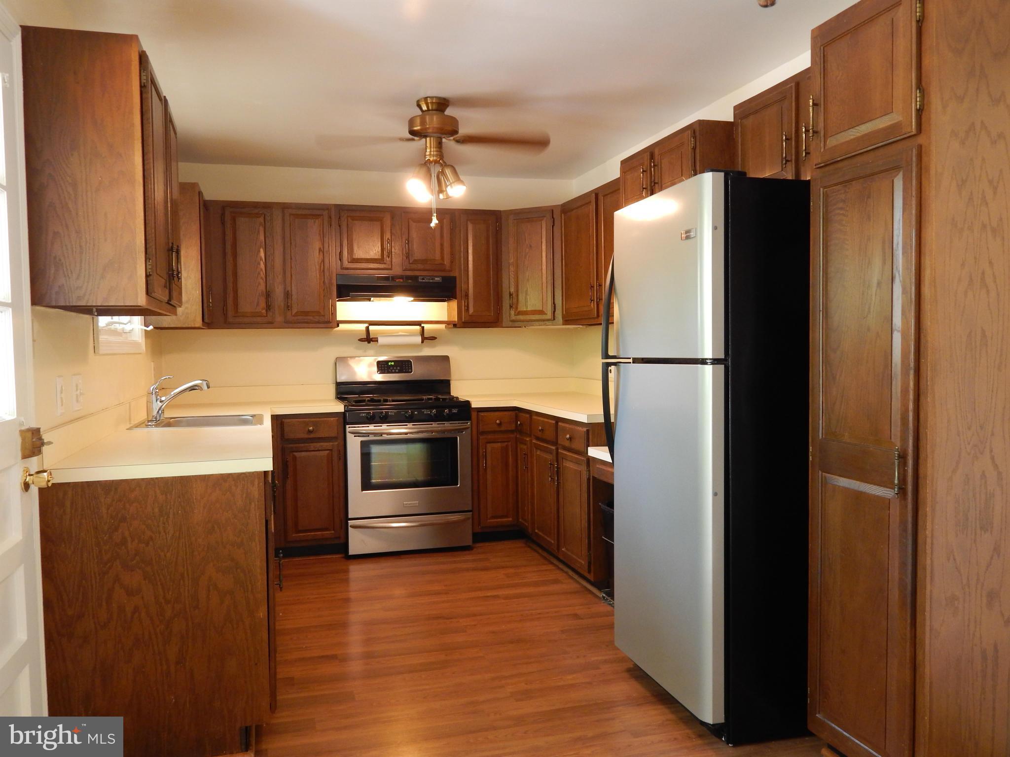 1912 Tadcaster Road Catonsville, MD 21228 - Photo 12 of 26 a kitchen with a refrigerator a stove top oven a sink and dishwasher