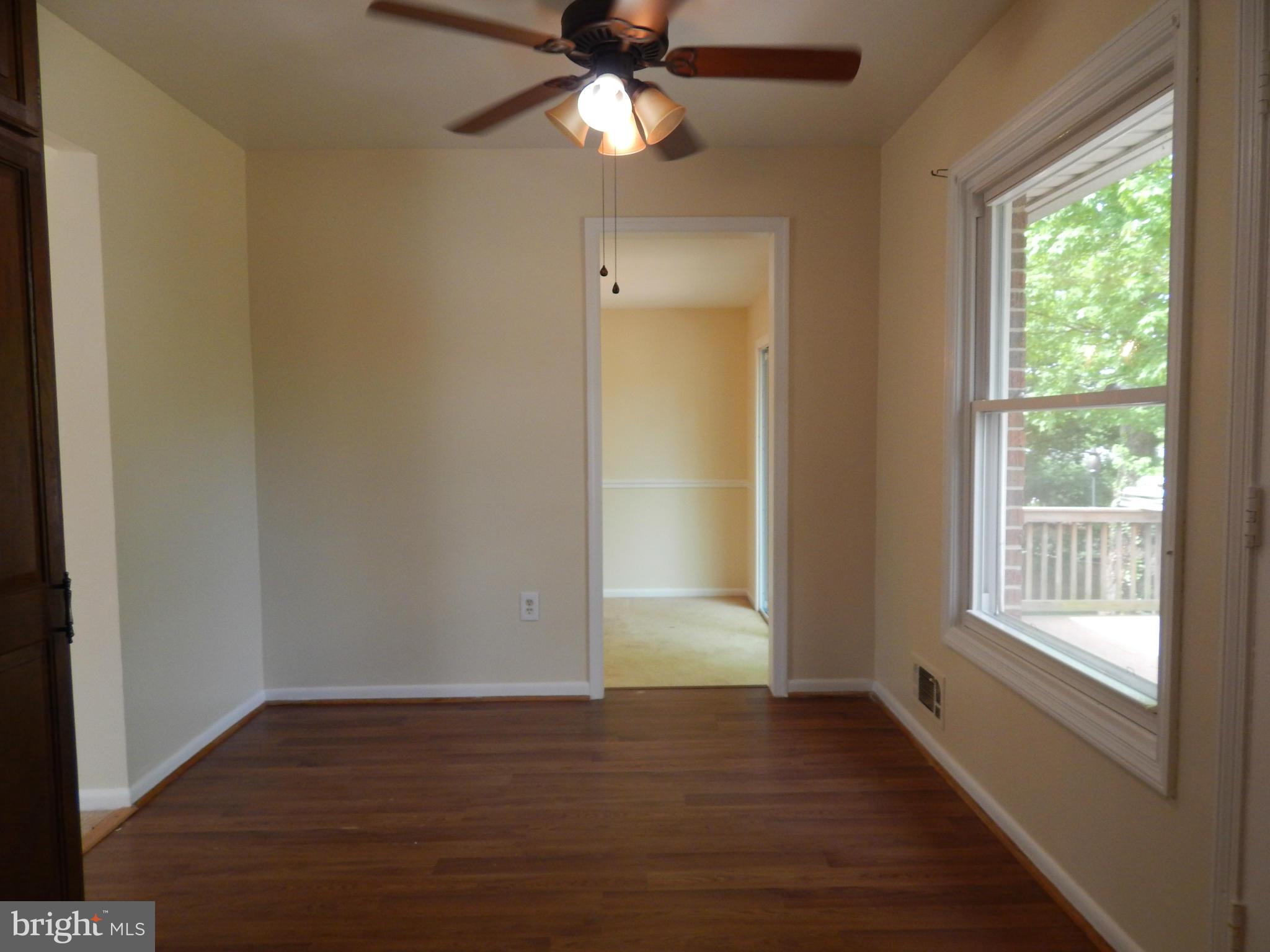 1912 Tadcaster Road Catonsville, MD 21228 - Photo 14 of 26 a view of an empty room with wooden floor and a window