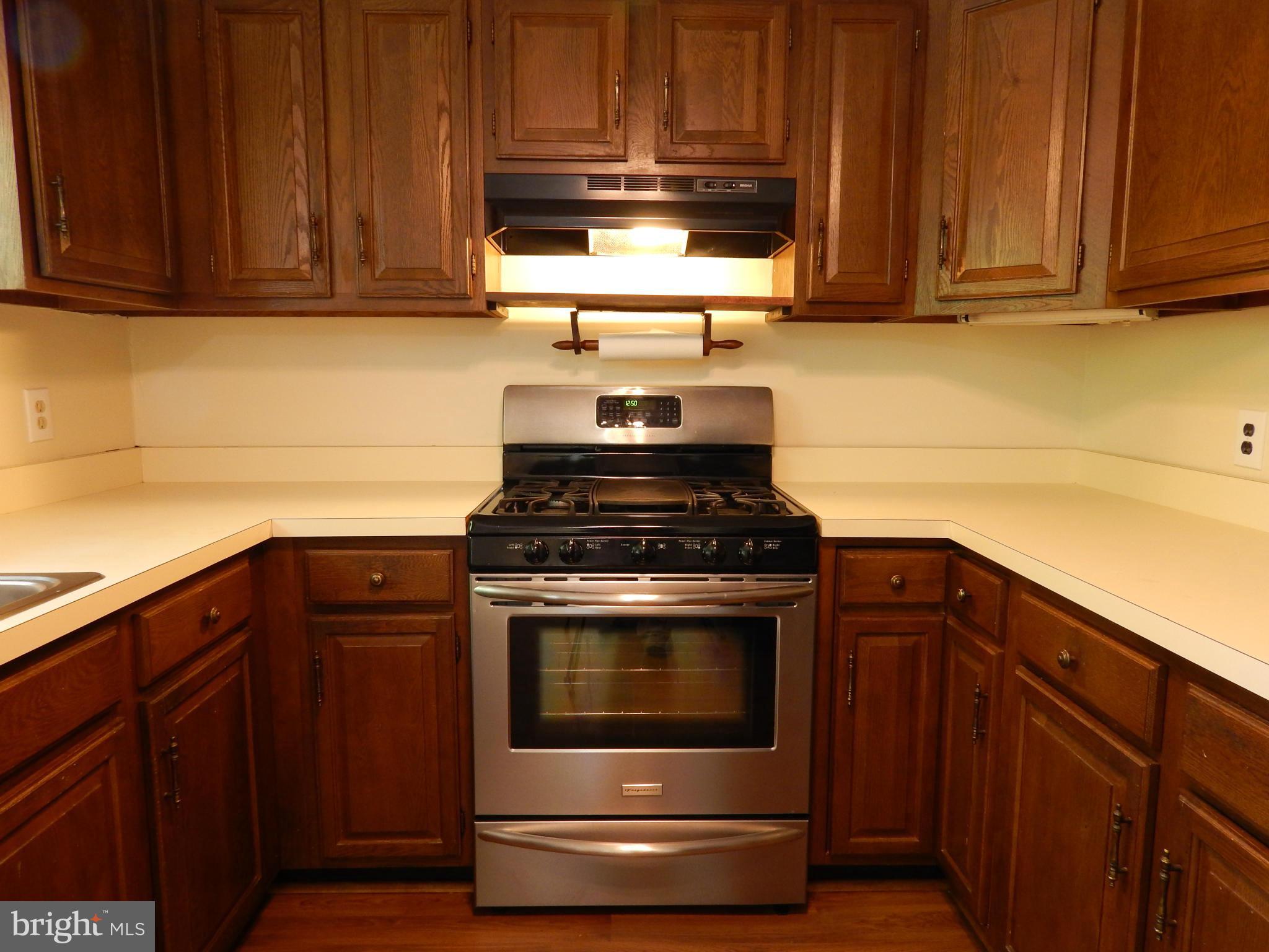 1912 Tadcaster Road Catonsville, MD 21228 - Photo 15 of 26 a kitchen with granite countertop wood cabinets and stainless steel appliances