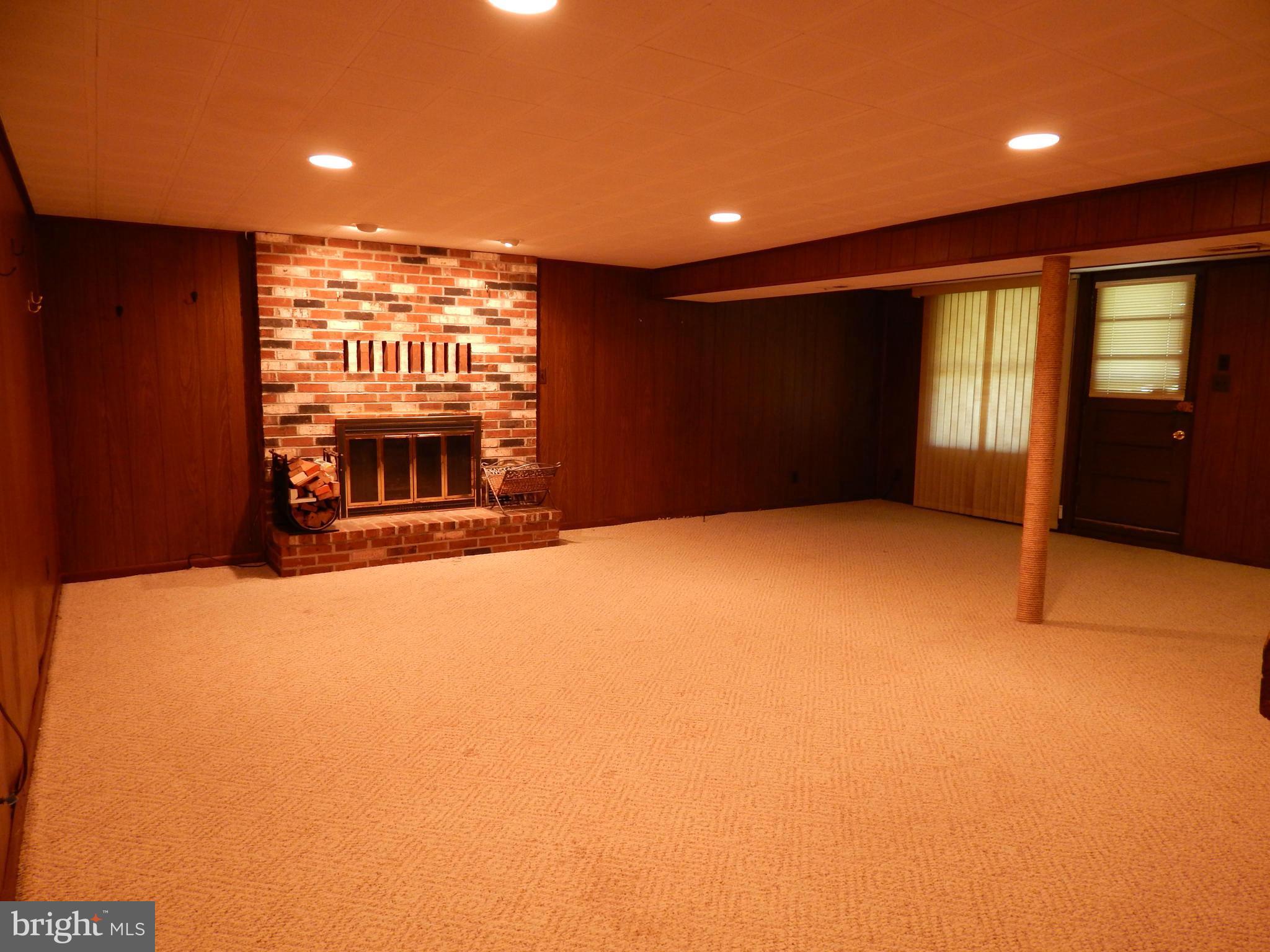 1912 Tadcaster Road Catonsville, MD 21228 - Photo 17 of 26 a view of an empty room with a fireplace and a window