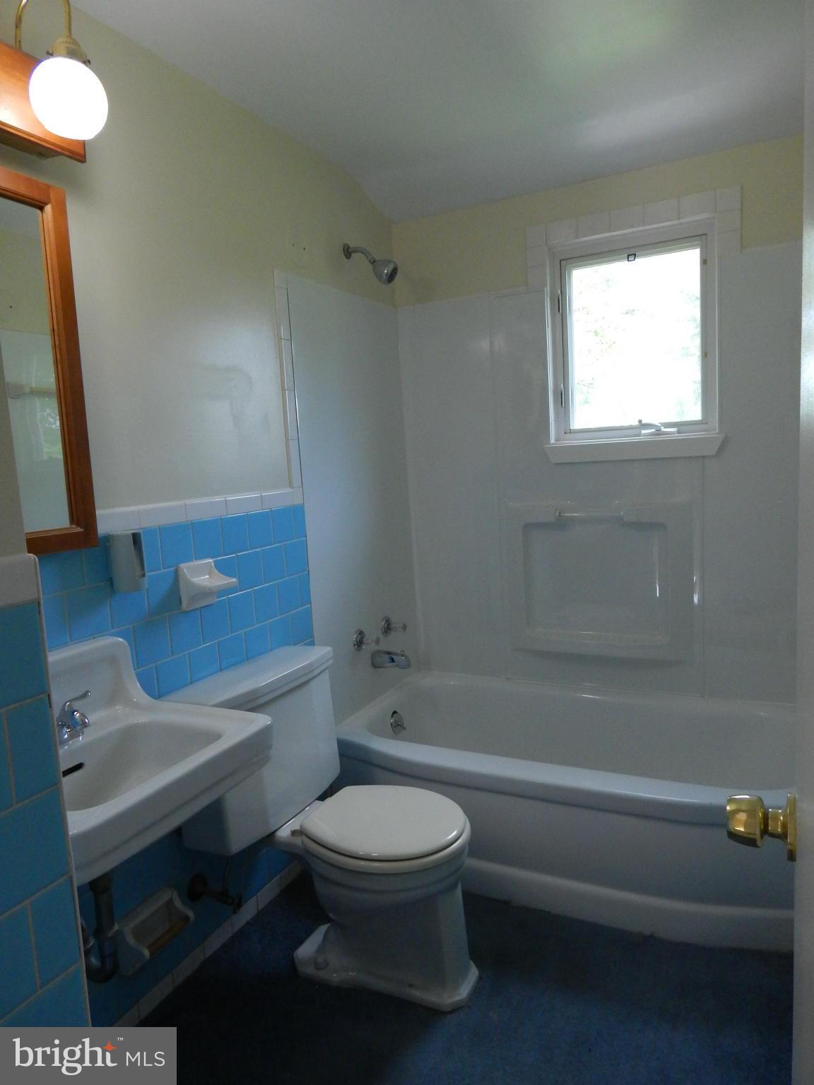 1912 Tadcaster Road Catonsville, MD 21228 - Photo 21 of 26 a bathroom with a toilet a sink and bathtub