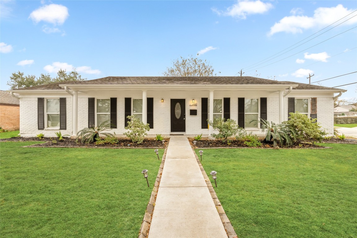 a front view of a house with yard patio and green space