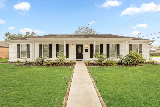 a front view of a house with yard patio and green space