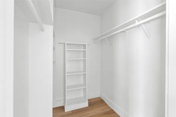 a view of walk in closet with empty racks