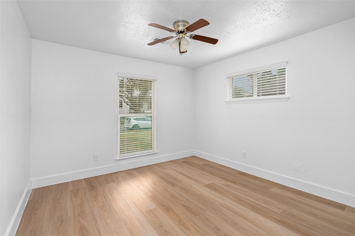 4947 Cheena Drive Houston, TX 77096 - Photo 12 of 18 an empty room with wooden floor and windows