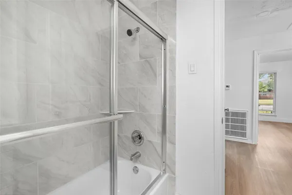 a bathroom with a bathtub and a shower