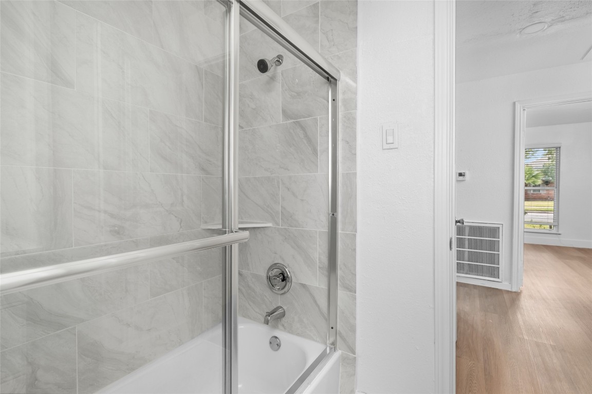 4947 Cheena Drive Houston, TX 77096 - Photo 14 of 18 a bathroom with a bathtub and a shower