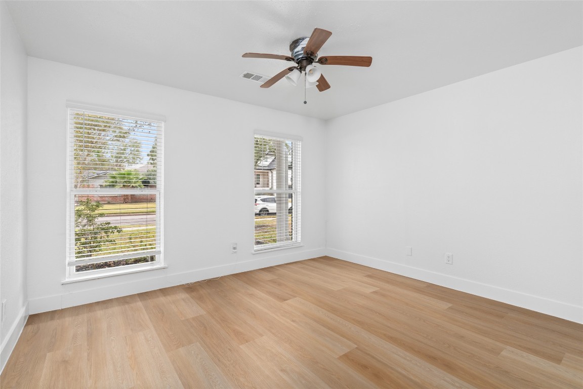 4947 Cheena Drive Houston, TX 77096 - Photo 15 of 18 wooden floor in an empty room with a window