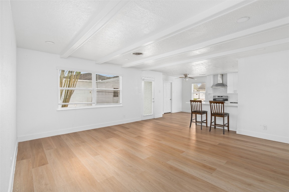 4947 Cheena Drive Houston, TX 77096 - Photo 7 of 18 a view of an empty room with window and wooden floor