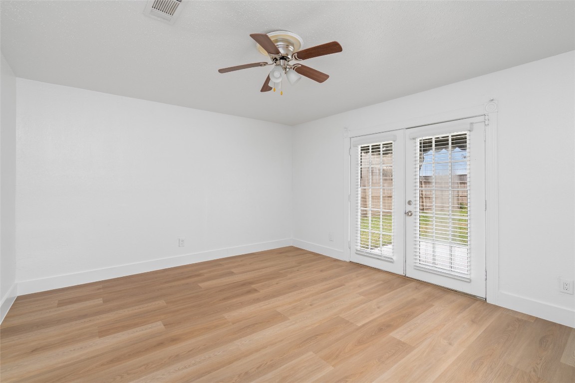 4947 Cheena Drive Houston, TX 77096 - Photo 8 of 18 an empty room with wooden floor and ceiling fan