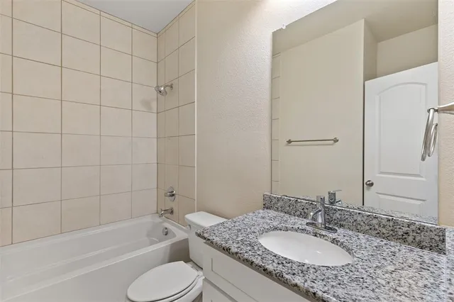 a bathroom with a bathtub and a toilet