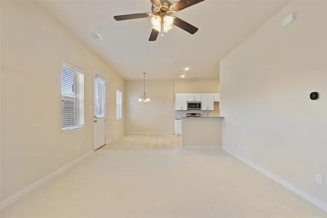 a view of kitchen with microwave and refrigerator