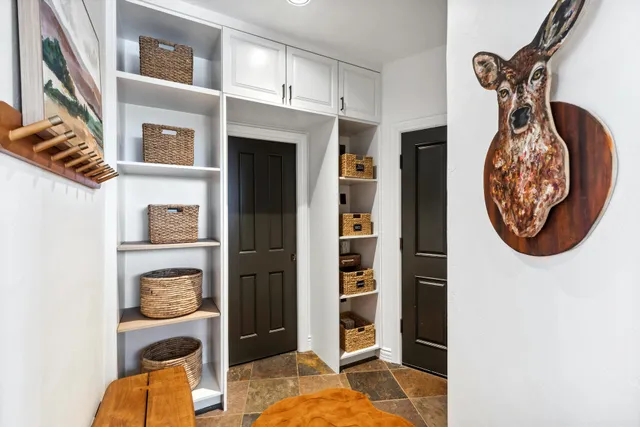 a view of walk in closet with clothes and shoes