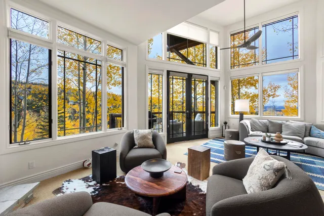 a living room with furniture windows and a flat screen tv