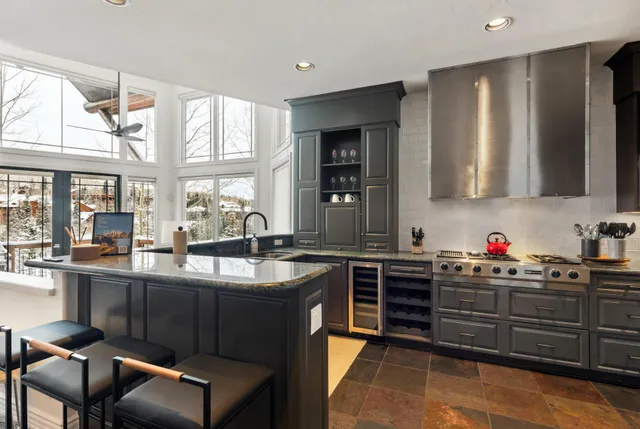 a kitchen with stainless steel appliances kitchen island granite countertop a sink and cabinets