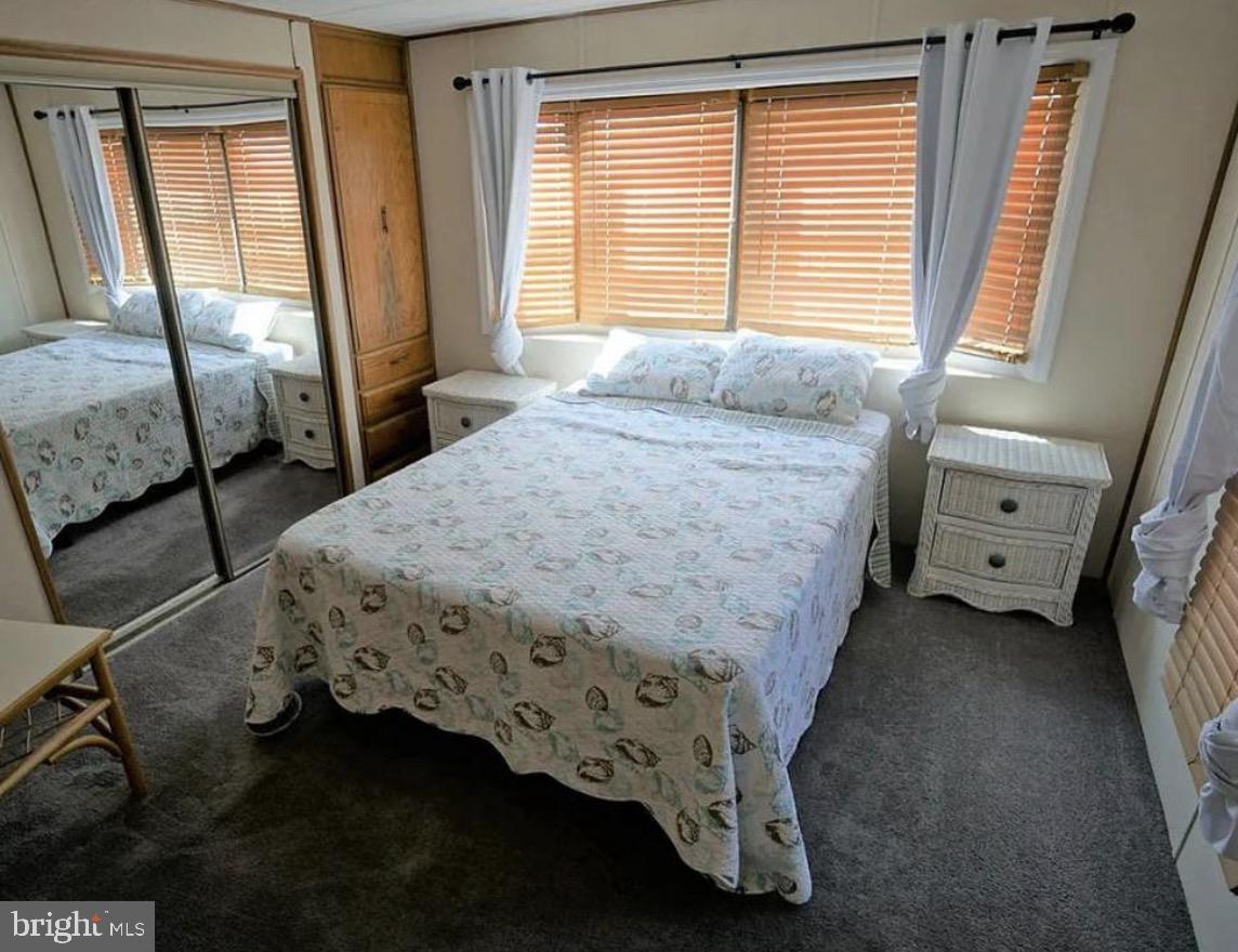 142 Peachtree Road Ocean City, MD 21842 - Photo 11 of 14 a bedroom with a bed and a window with chair