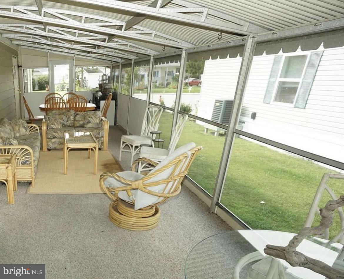 142 Peachtree Road Ocean City, MD 21842 - Photo 12 of 14 a view of a chairs with a table in balcony