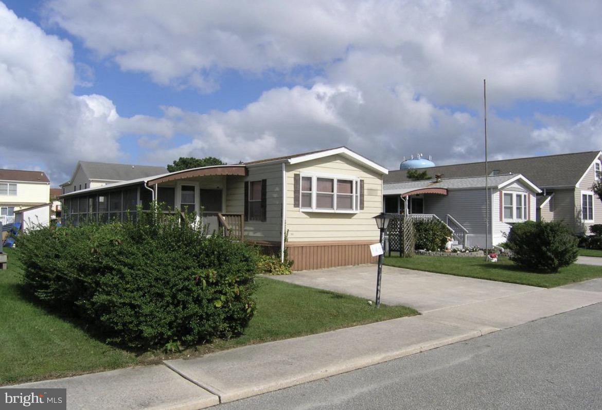 142 Peachtree Road Ocean City, MD 21842 - Photo 7 of 14 a front view of a house with a yard and potted plants
